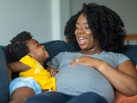 a pregnant mother and her daughter