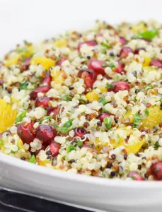 bowl of quinoa, with other chopped vegetables and herbs and pomegranate seeds