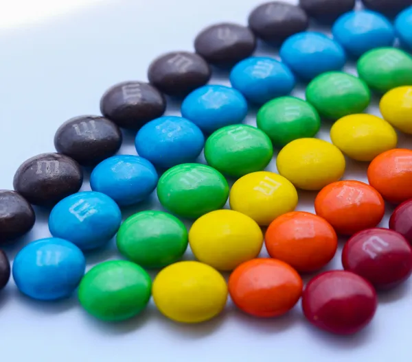 M&Ms candy arranged by color to resemble a rainbow