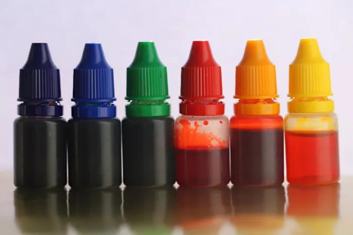 Six bottles of artificial food coloring, also called synthetic food dye