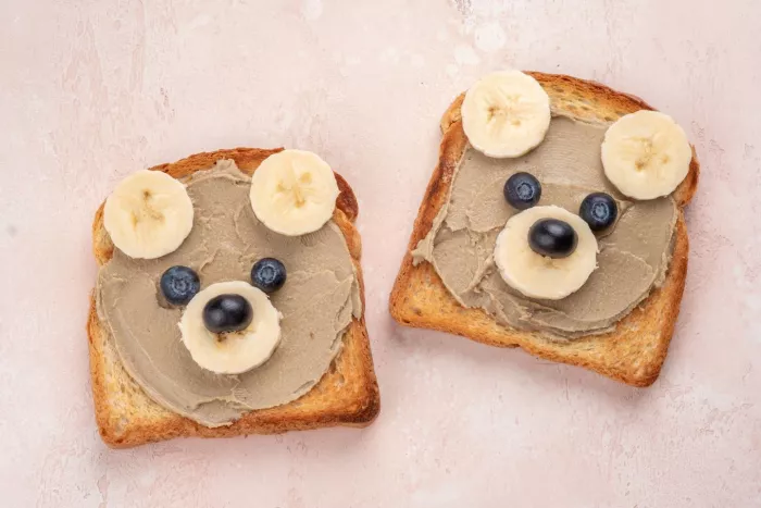 Funny children bear toasts with sunbutter or other nut butter