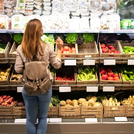 woman in produce section of grocery store