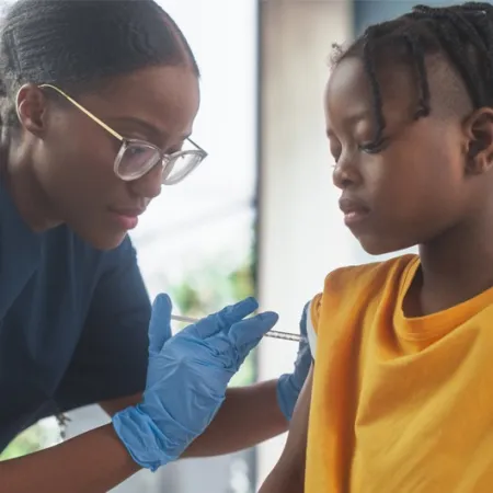 doctor giving child a vaccine in arm